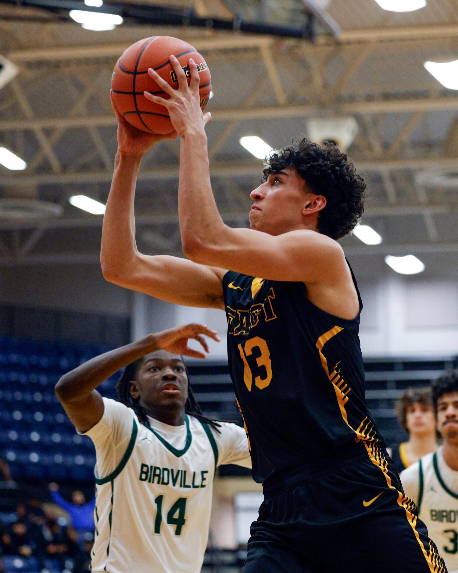 Plano East forward Moustafa Abualneel (13) drives to the basket past Birdville guard Jacob...