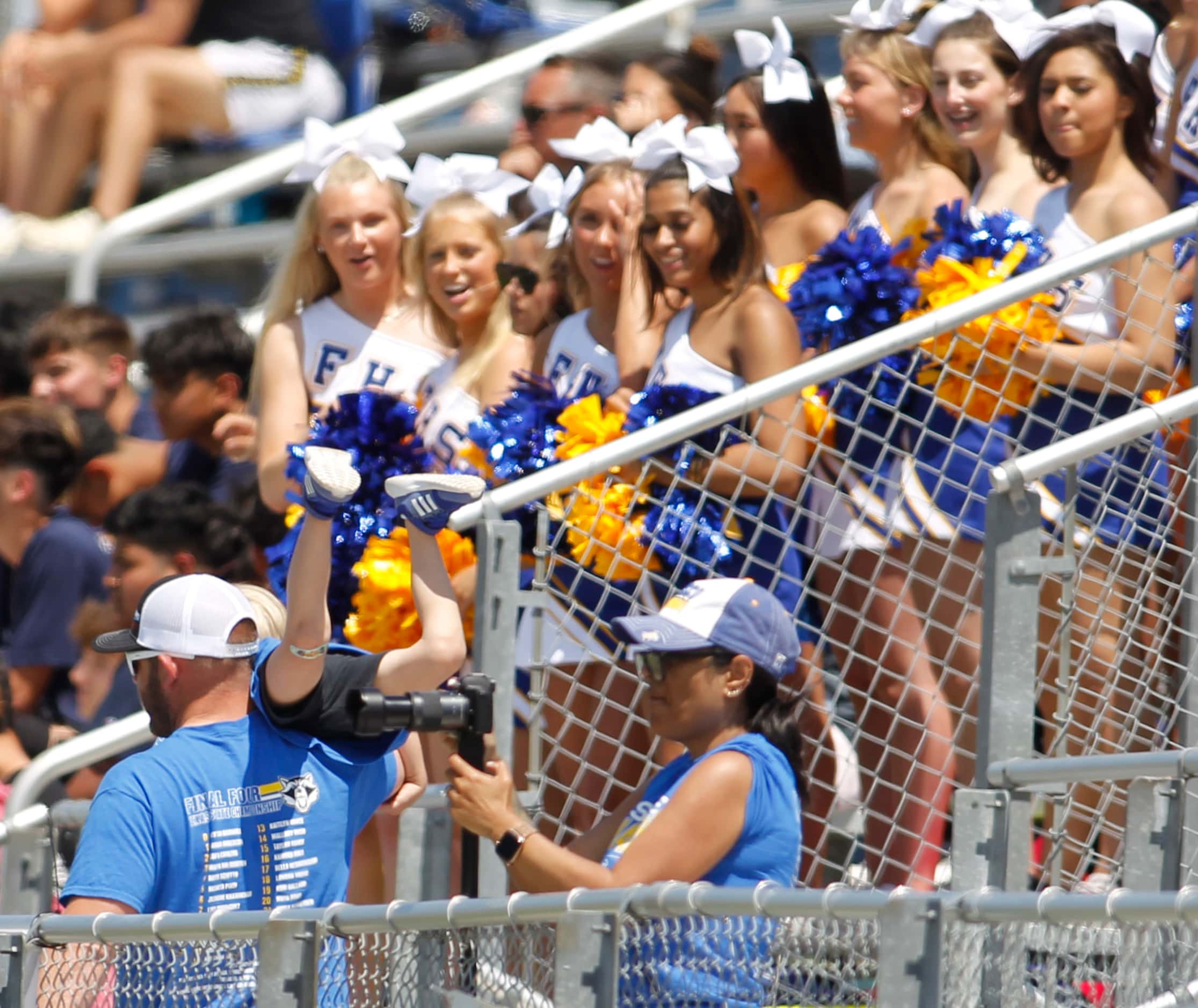 A Frisco fan gives his son a ride on his shoulder during first half action against...