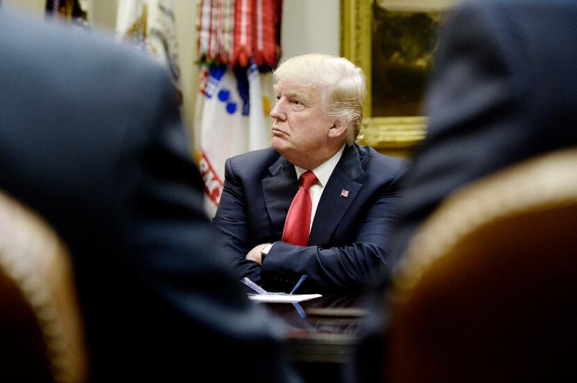 U.S. President Donald Trump looks on during a meeting with the National Association of...