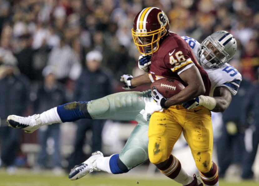 Dallas Cowboys inside linebacker Ernie Sims (59) tackles Washington Redskins running back...