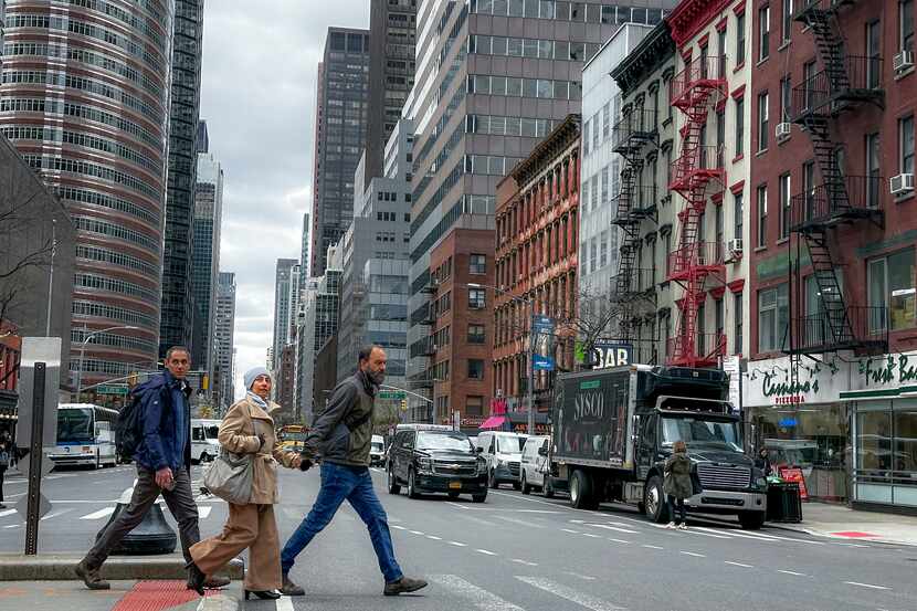 CORRECTS DAY TO FRIDAY - Pedestrians cross the street in New York on Friday, April 5, 2024....