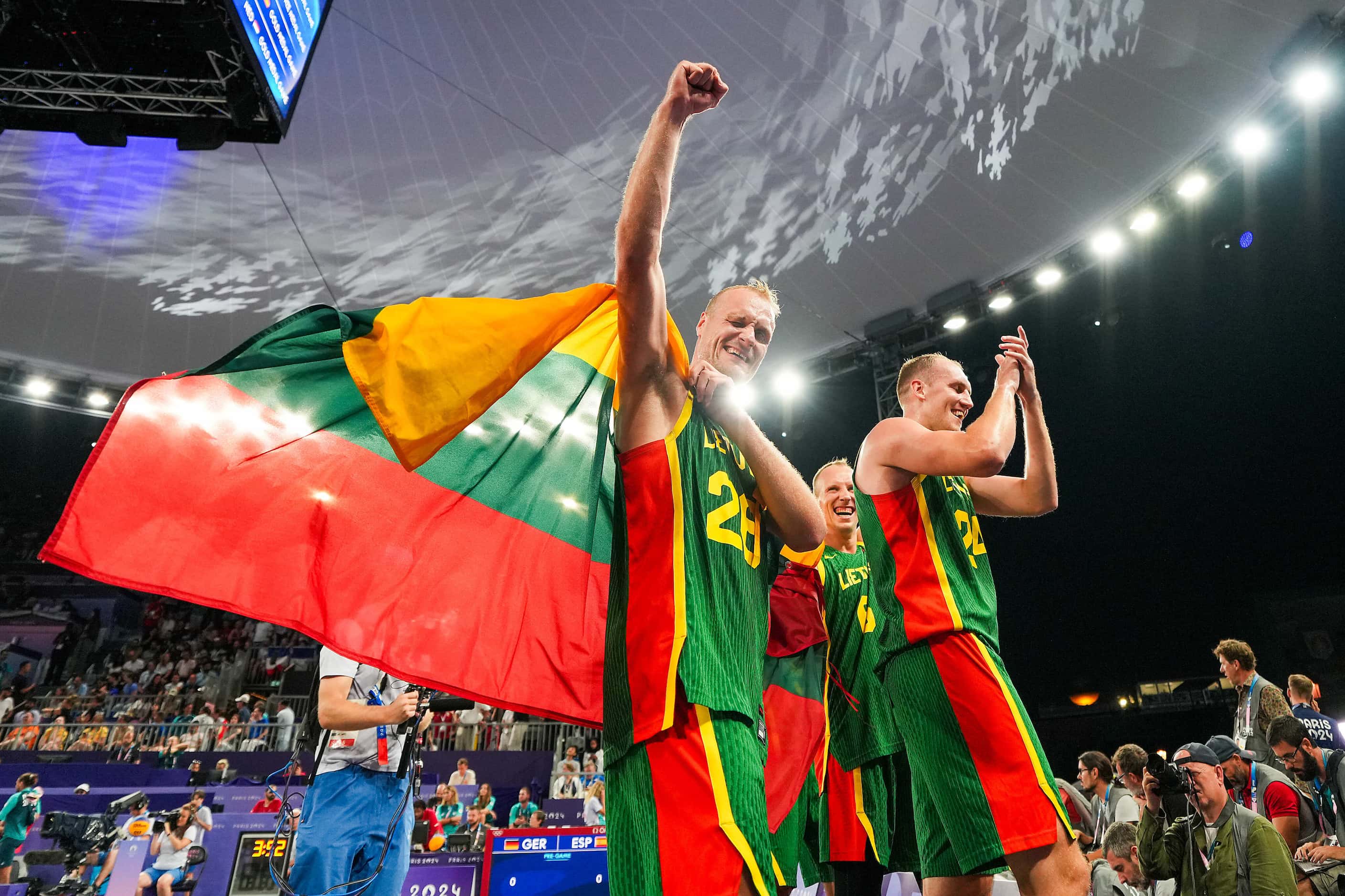 Lithuania’s Evaldas Dziaugys (26) celebrates after a victory in the men’s 3x3 basketball...