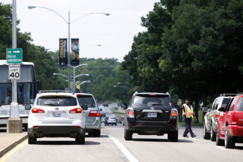 Police stopped traffic on Garland Road to let a shuttle bus into the Dallas Arboretum on...