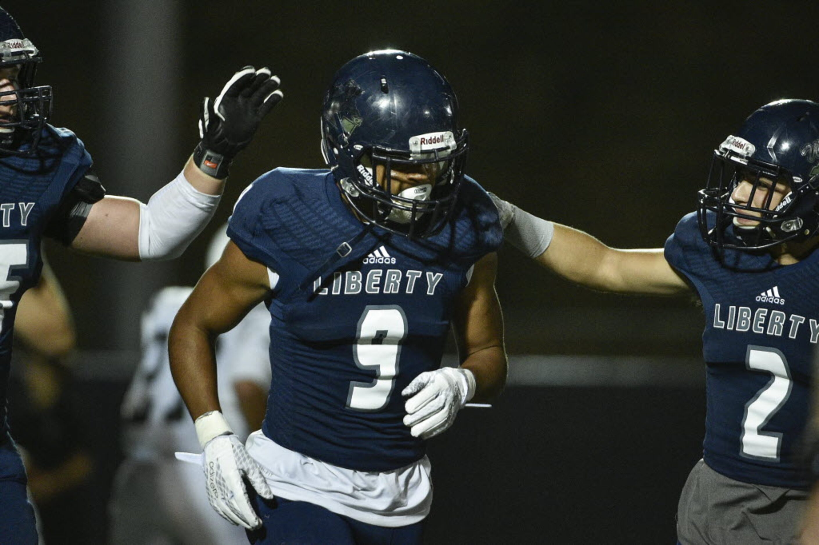 Liberty wide receiver Justus Lee (9) celebrates with teammates after kicking an extra point...