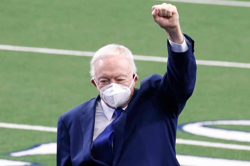 Dallas Cowboys owner and general manager Jerry Jones puts his fist in the air as he exits...