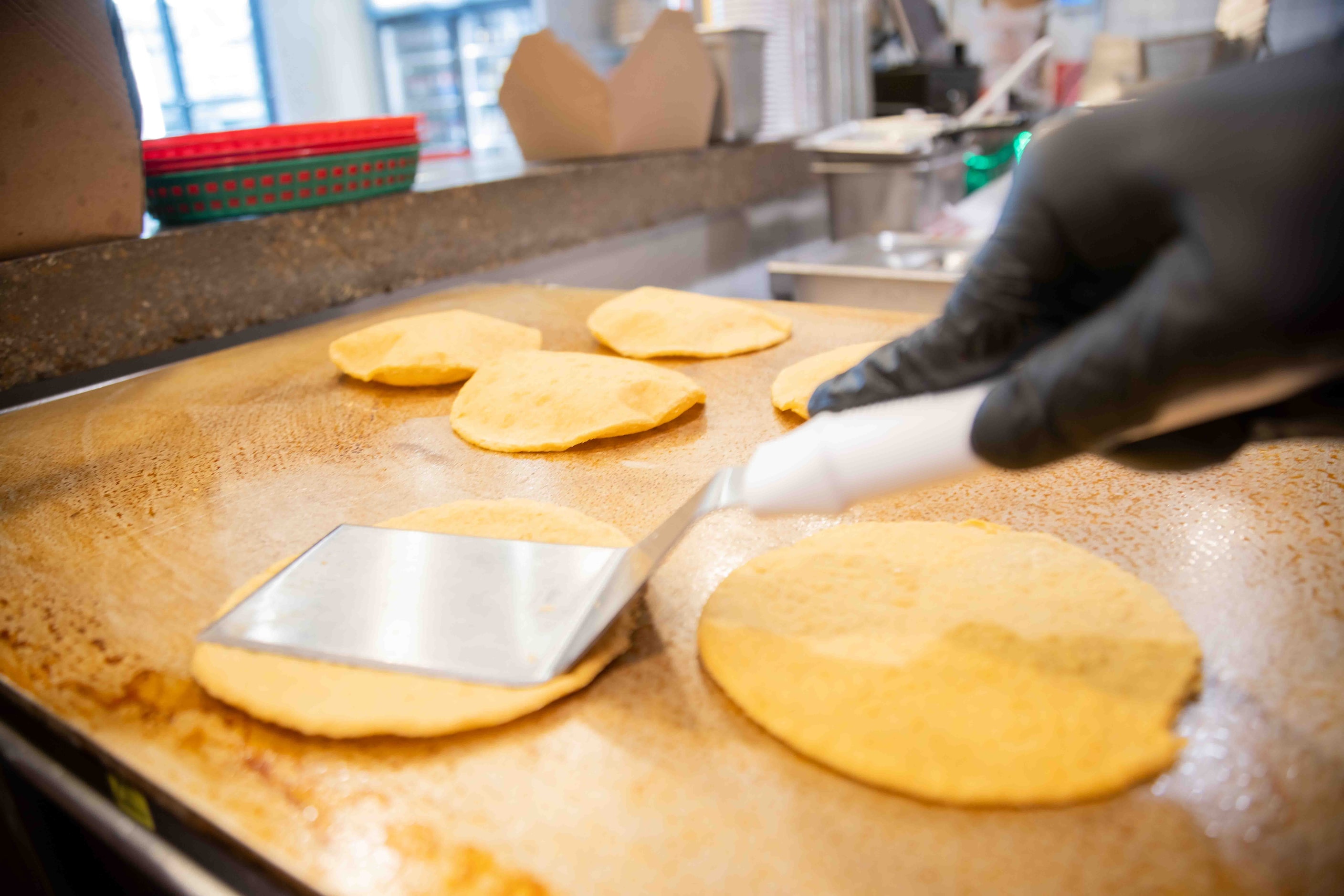 Enrique Peralta, regional manager of The Taco Stand, flips the tortillas at Taco Stand...