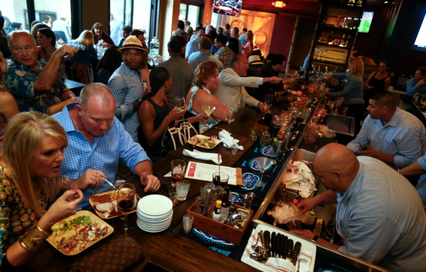 People eating during the opening party of Hickory, Kent Rathbun's new restaurant in Plano on...