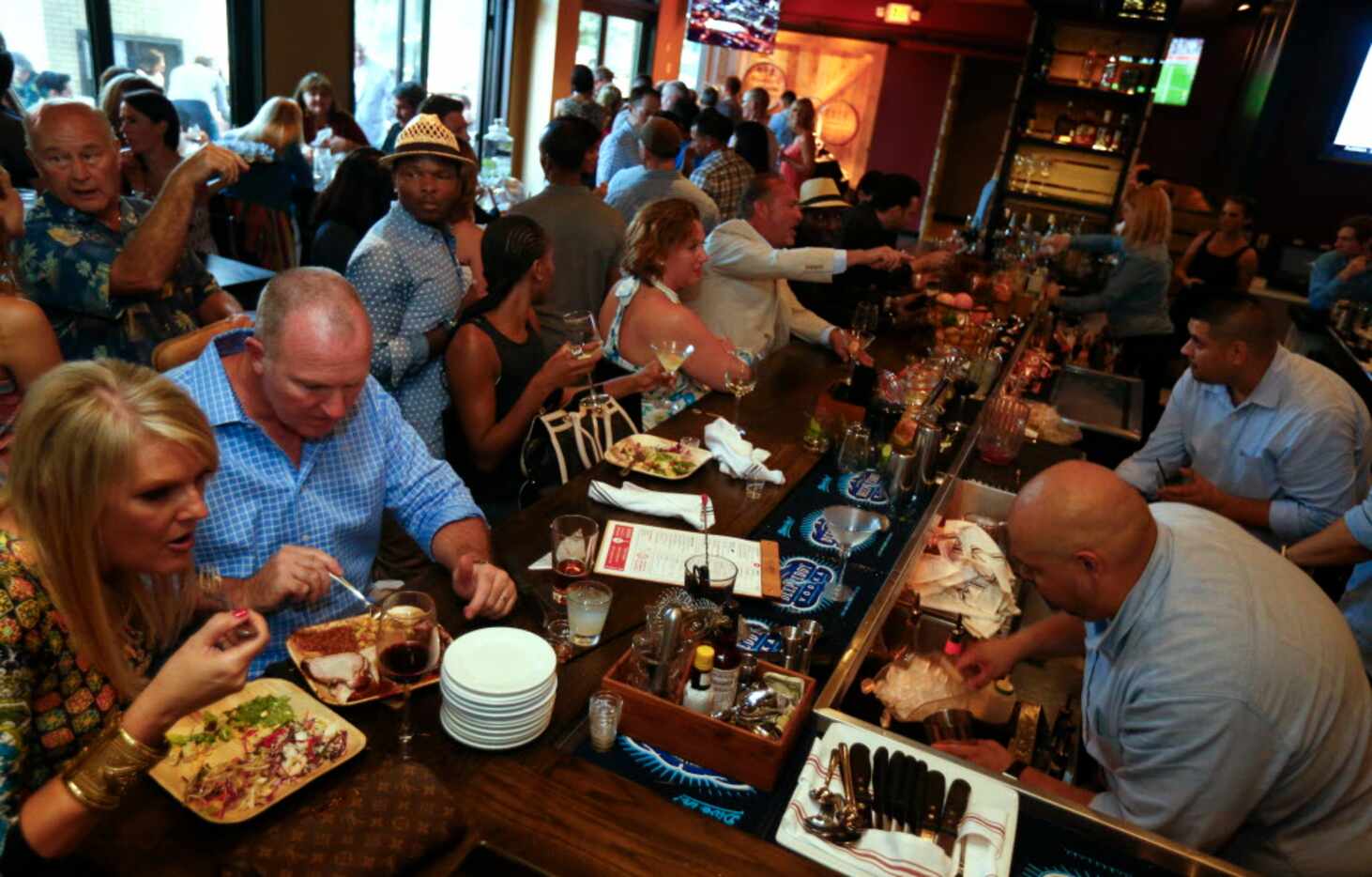 People eating during the opening party of Hickory, Kent Rathbun's new restaurant in Plano on...