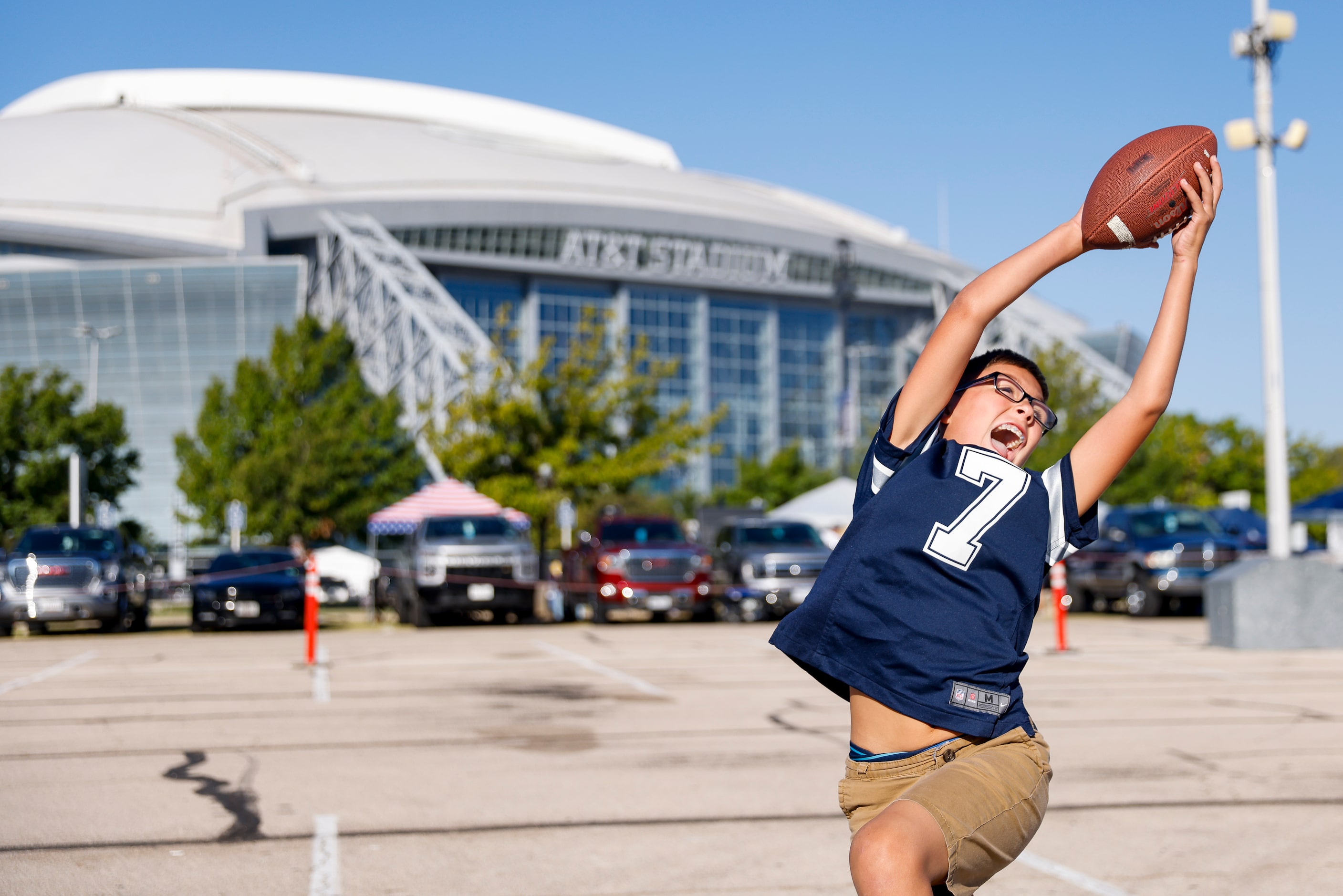 Caleb Malik, 10, plays catch before the Washington Commanders at Dallas Cowboys game on...