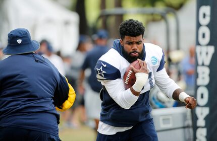 Cowboys running back Ezekiel Elliott (21) works with running backs coach Gary Brown during...