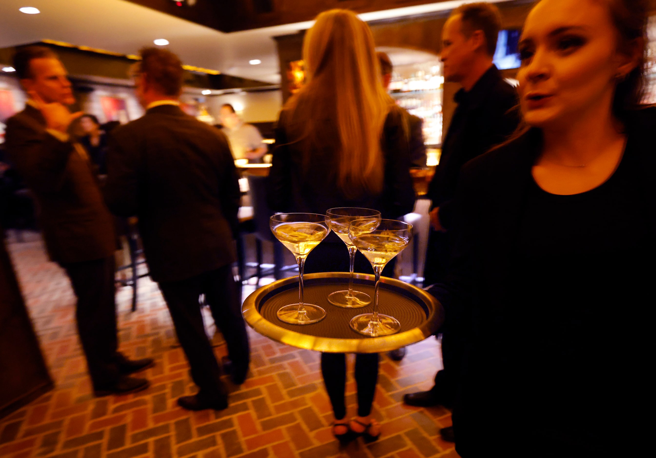 Champagne is served to those gathered for a press event at Red Phone Booth, a speakeasy in...