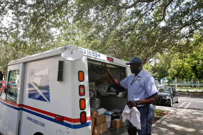 In this 2018 file photo, Elston Bradshaw delivers mail to an apartment complex in Florida....