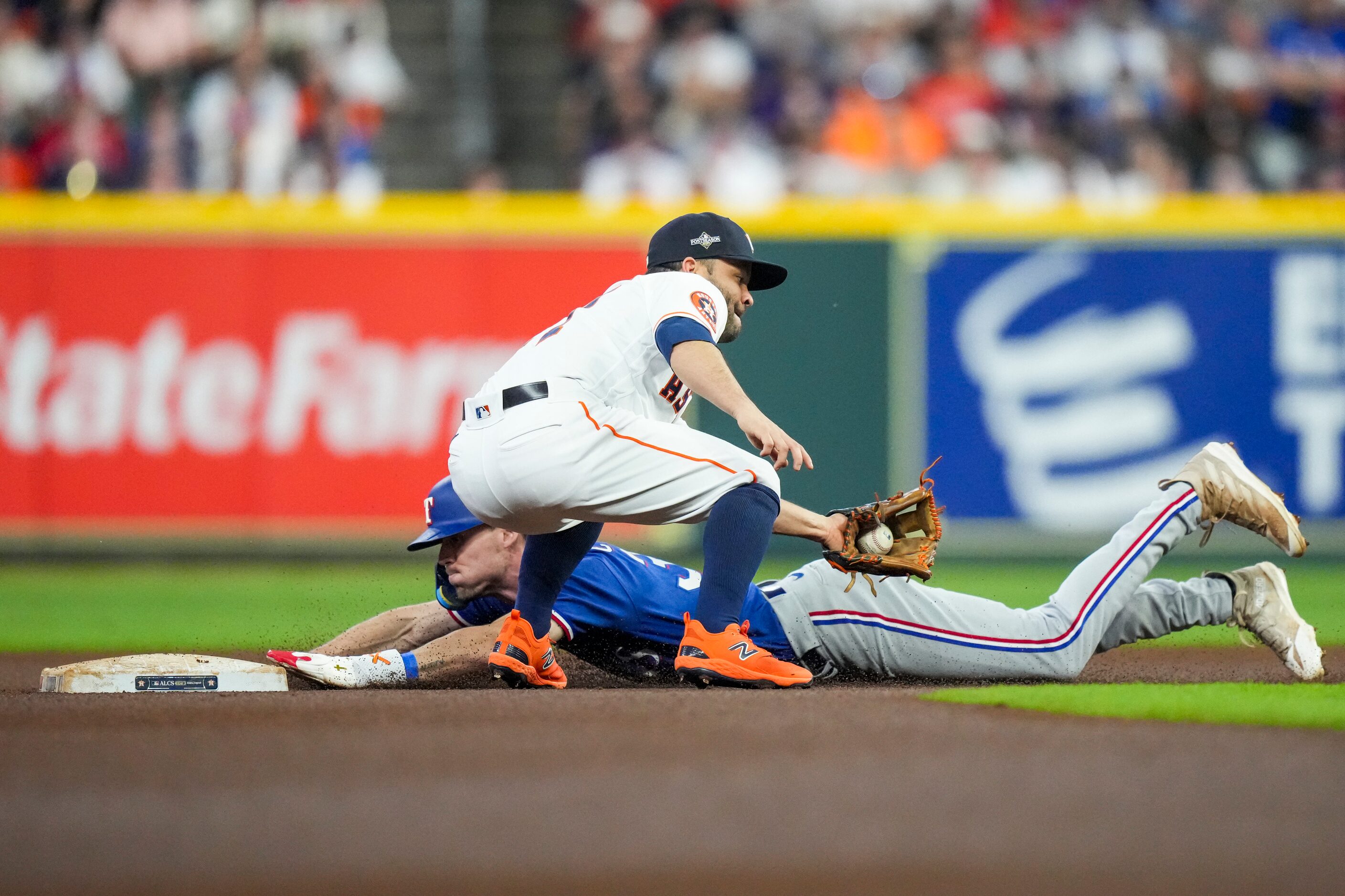 Texas Rangers left fielder Evan Carter (32) steals second base in front of Houston Astros...