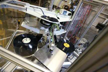 Records sit in a album press at Hand Drawn Pressing in Addison, Texas.