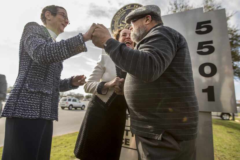 Rabbi Kerry Baker, right, holds hands with Sarah Goodfriend, left, and Suzanne Bryant during...