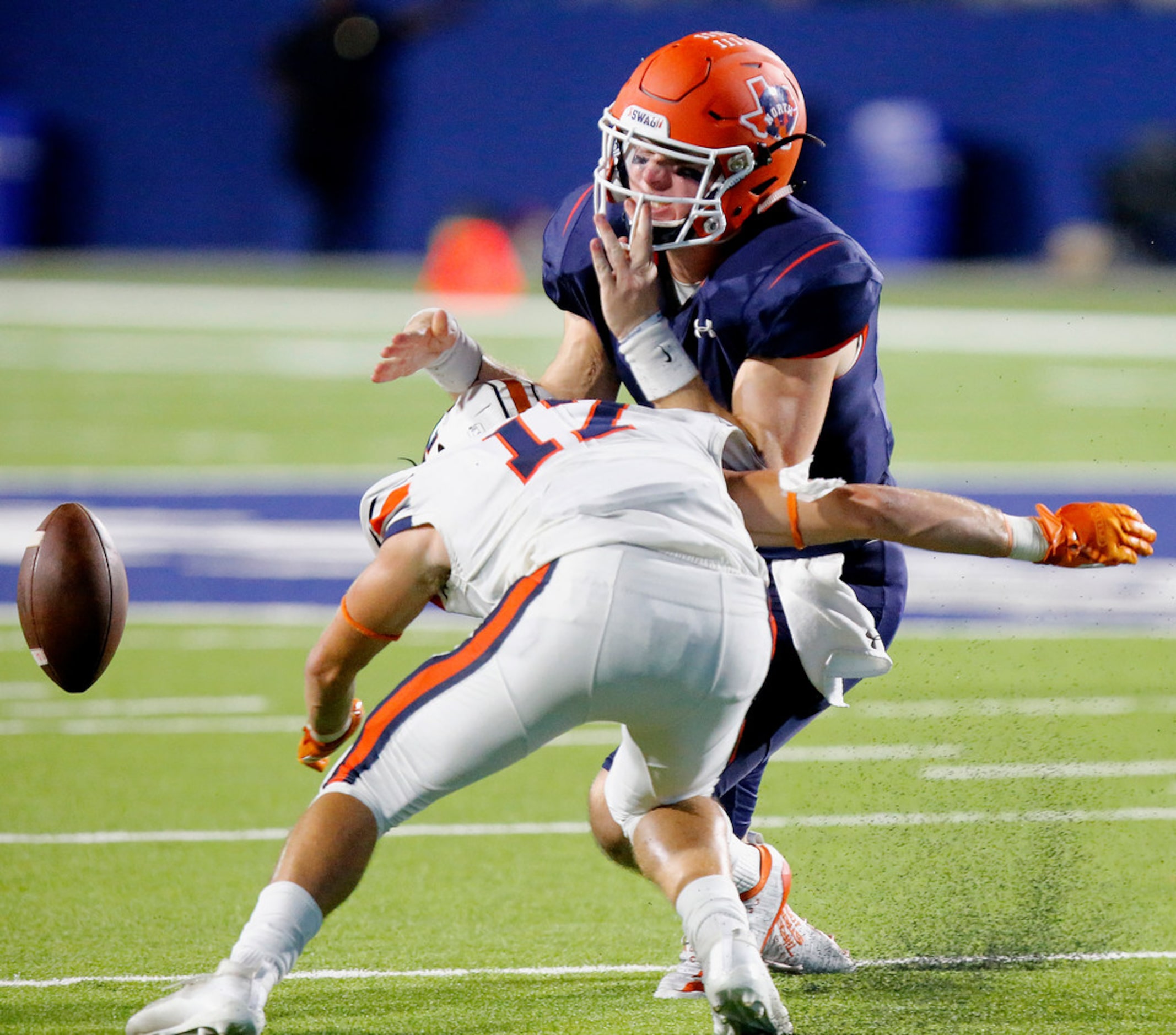 McKinney North High School quarterback Dillon Markiewicz (4) fumbles the football after...