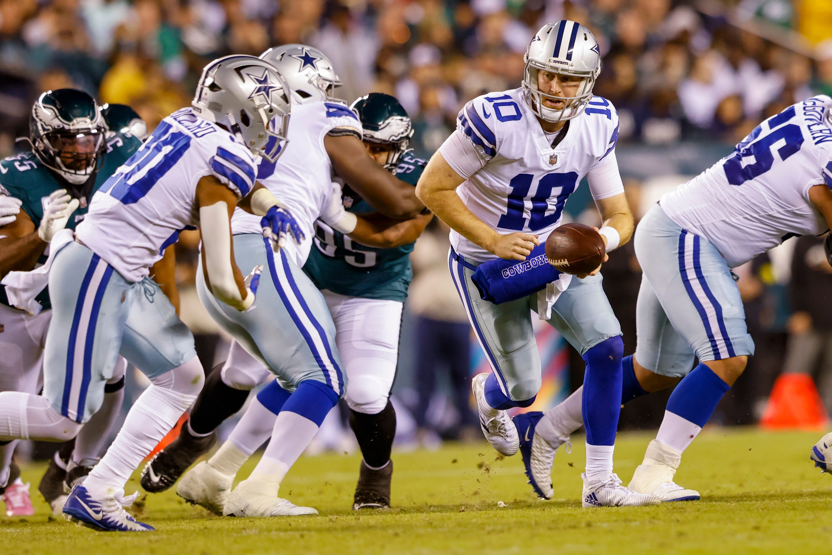 Dallas Cowboys quarterback Cooper Rush (10) runs during a play in the third quarter of a NFL...