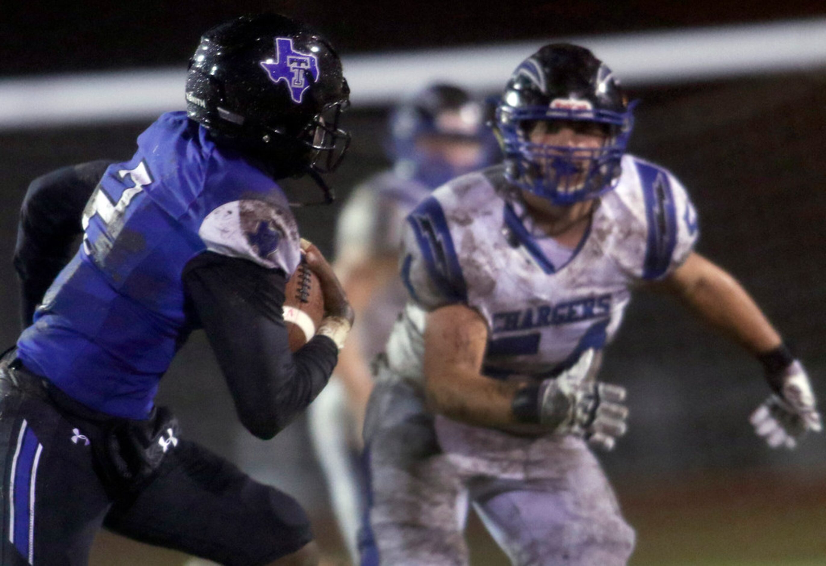 Trinity Christian-Cedar Hill quarterback Shedeur Sanders (2) rolls out of the pocket as...