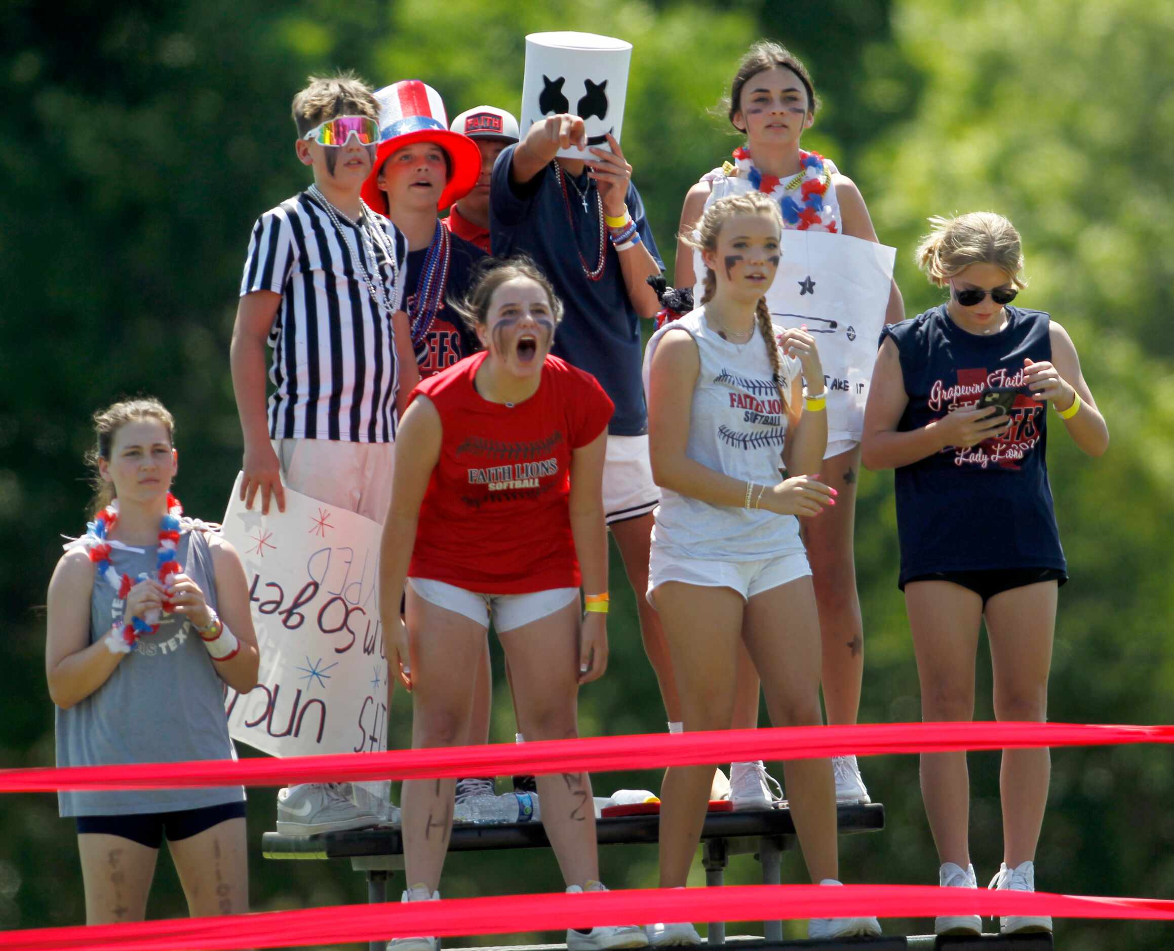Grapevine Faith Christian fans show their support from the left field bleachers during the...