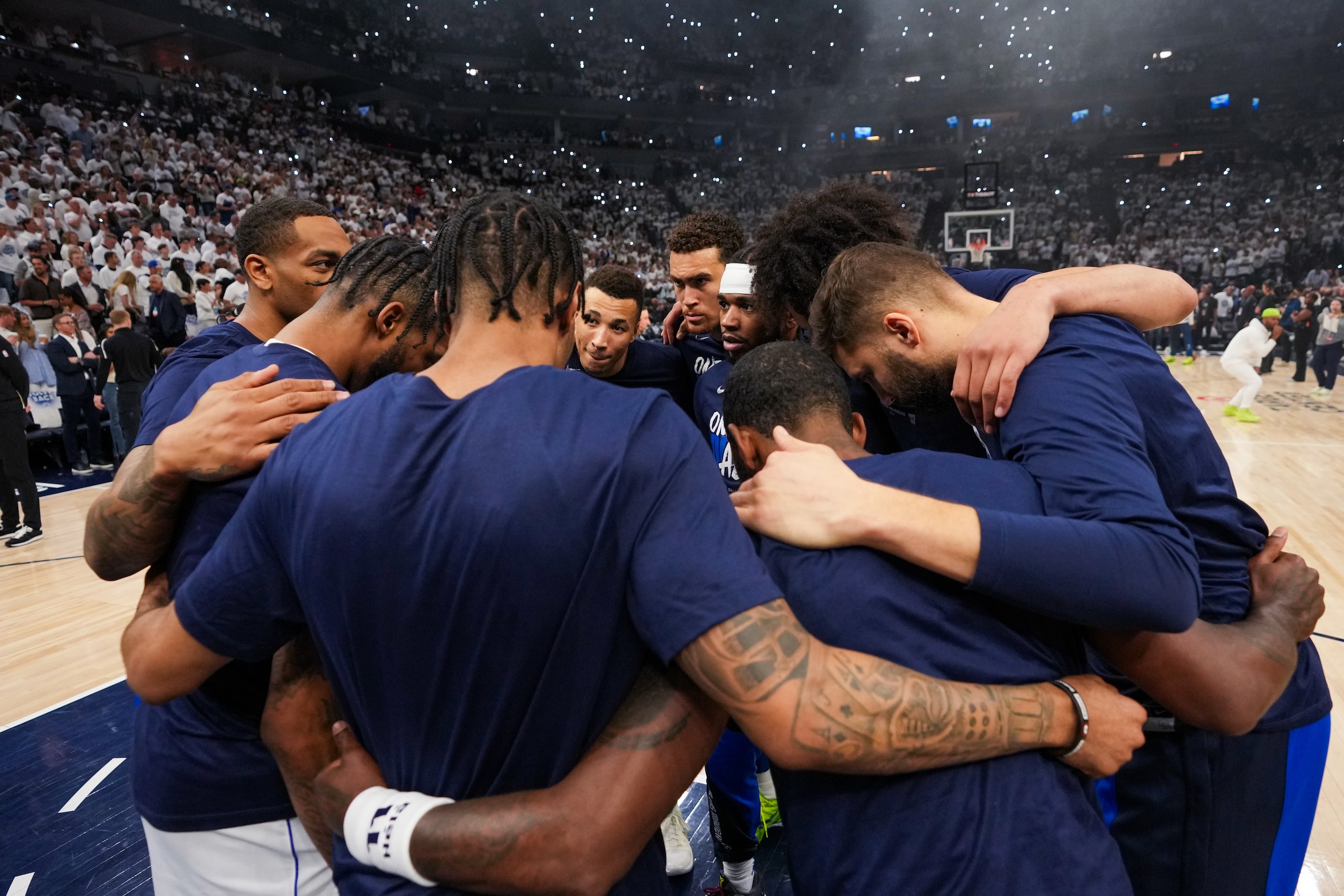 Dallas Mavericks players huddle on the court before Game 5 of the NBA basketball Western...