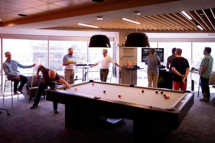 Employees played billiards and video games during a party celebrating the month's employee...