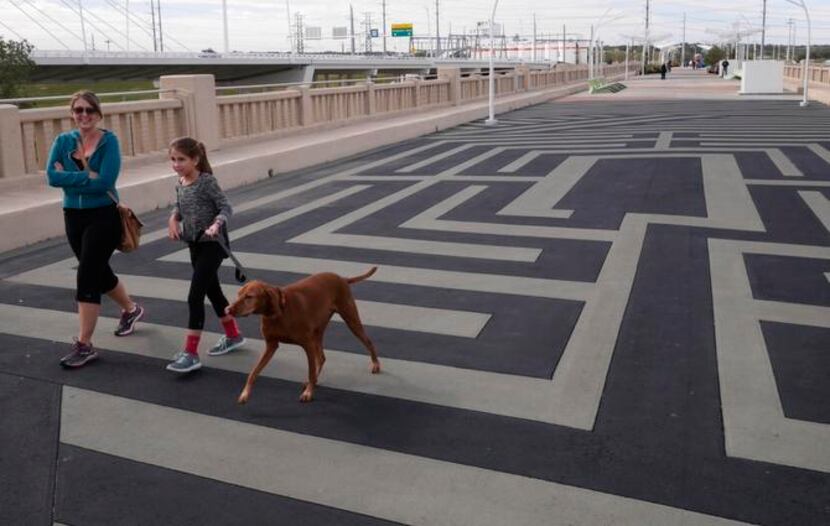 
From left, Nicole Loper, Chelsea Loper, 10, and Copper walk across the Labyrinth on the...
