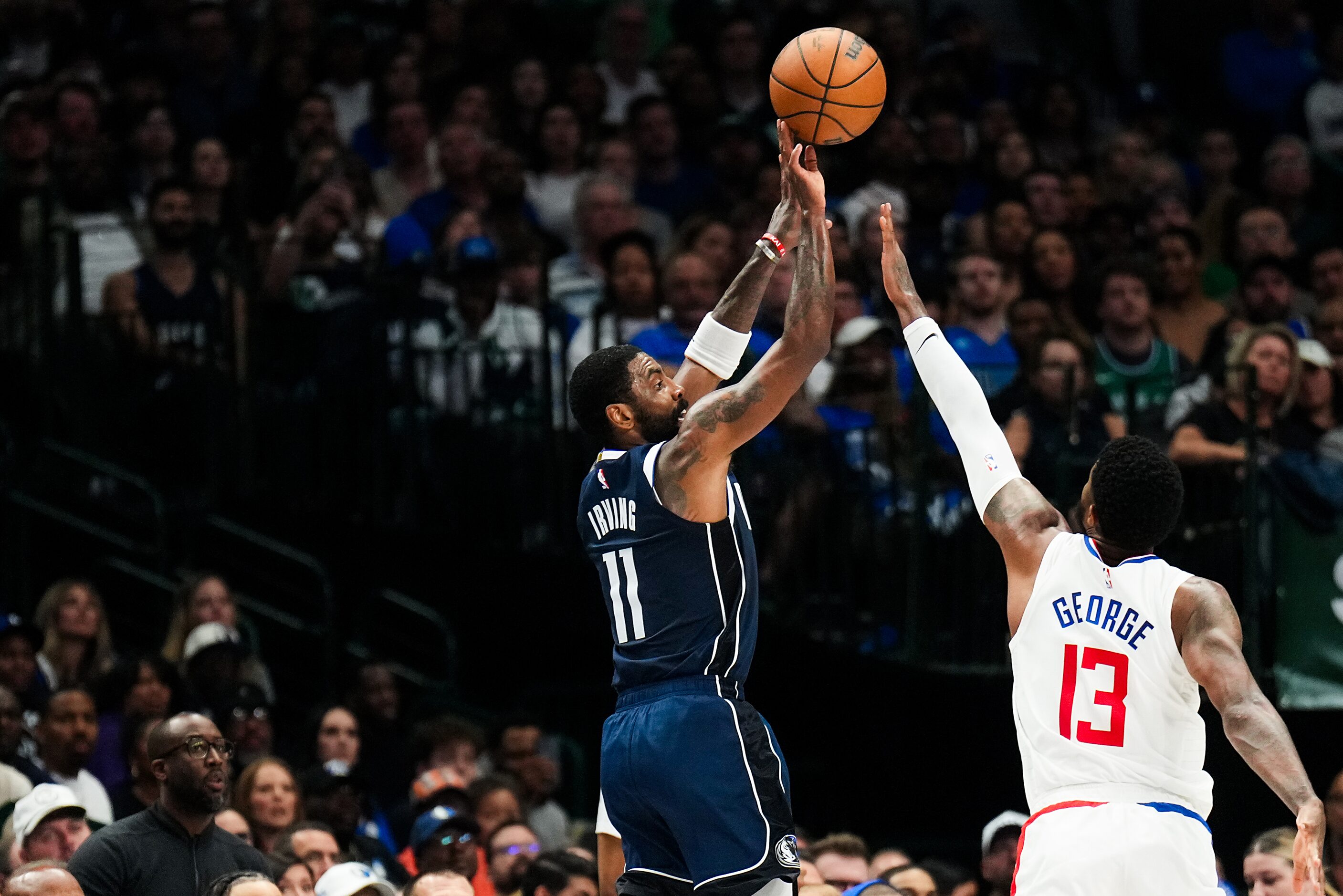 Dallas Mavericks guard Kyrie Irving (11) hits a three-pointer past LA Clippers forward Paul...