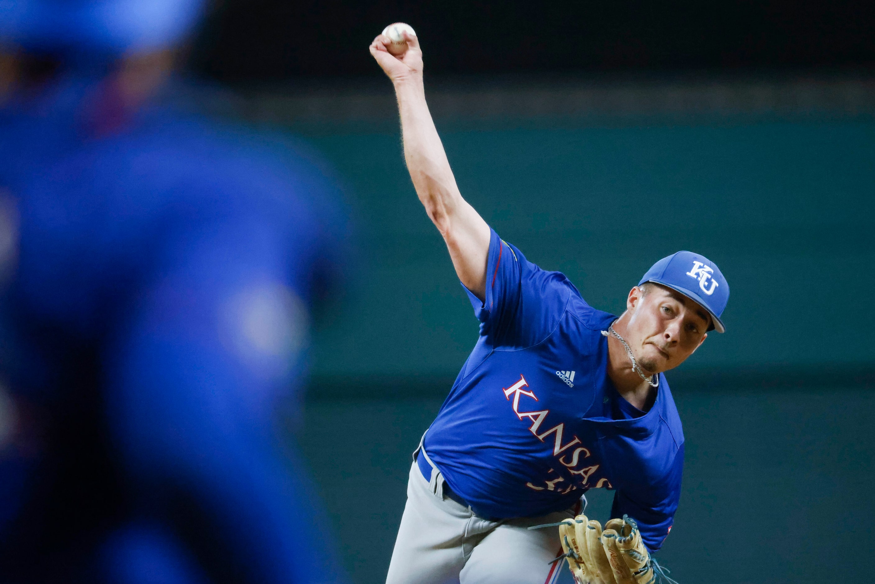 Kansas pitcher Kolby Dougan throws during the third inning of a baseball game against Kansas...