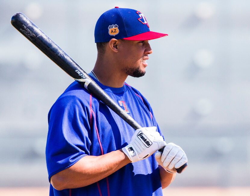 Texas Rangers center fielder Carlos Gomez (14) warm up before batting practice during a...