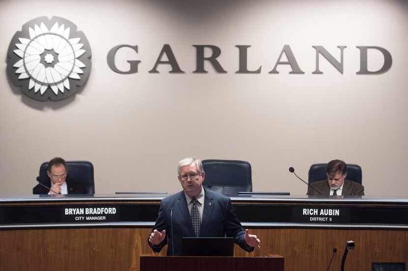Garland Mayor Douglas Athas reads from his resignation letter before the start of the city...