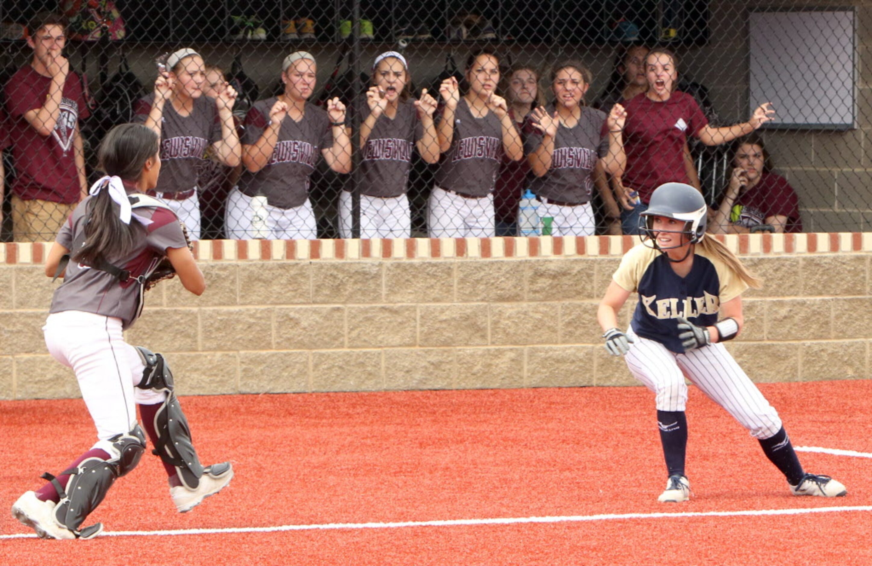 Lewisville catcher Gaby Vasquez (0) aggressively runs down Keller baserunner Camryn Woodall...