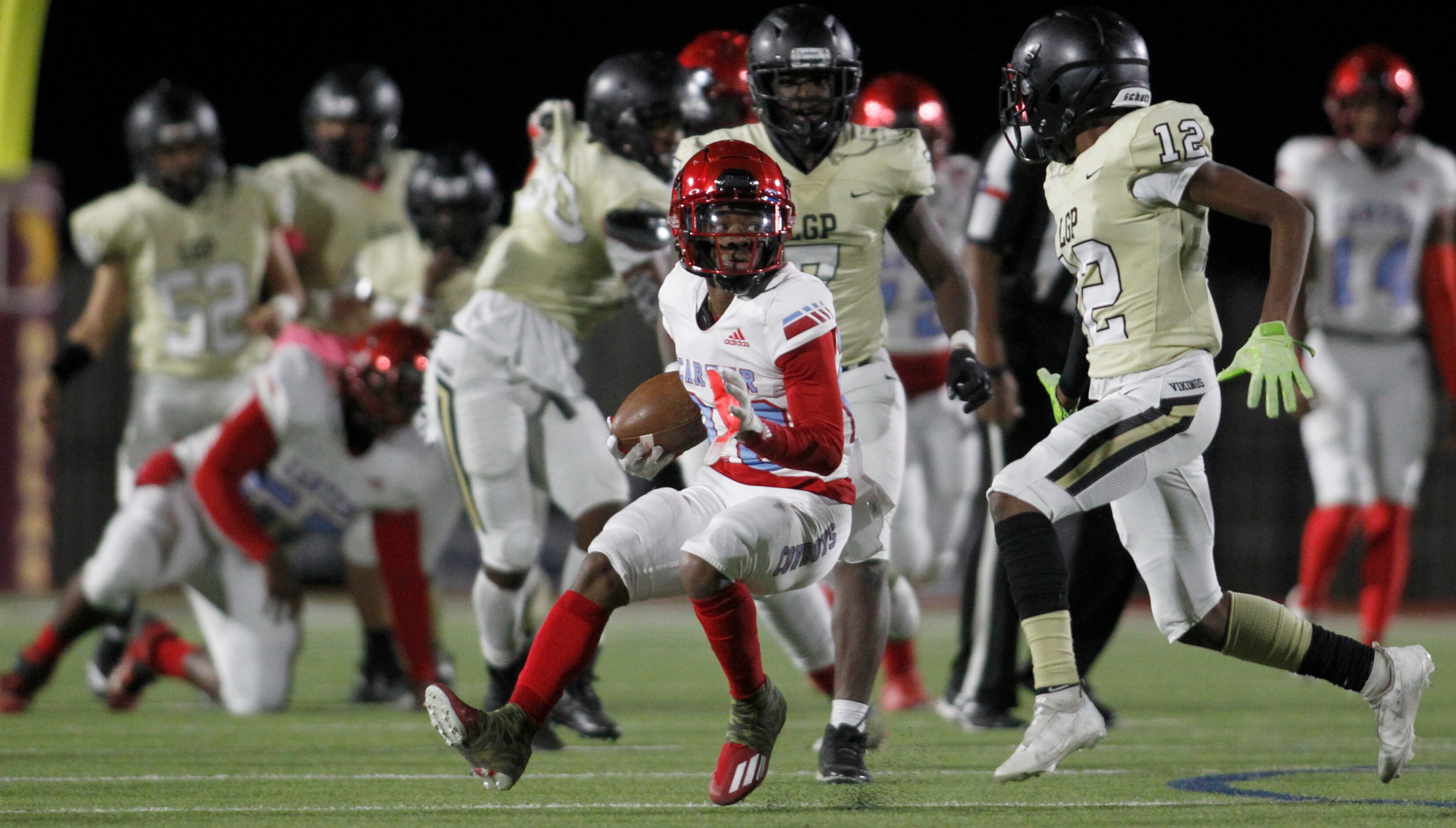 Dallas Carter's Brandon Williams (22) eyes the defense of Dallas Pinkston safety Josh...