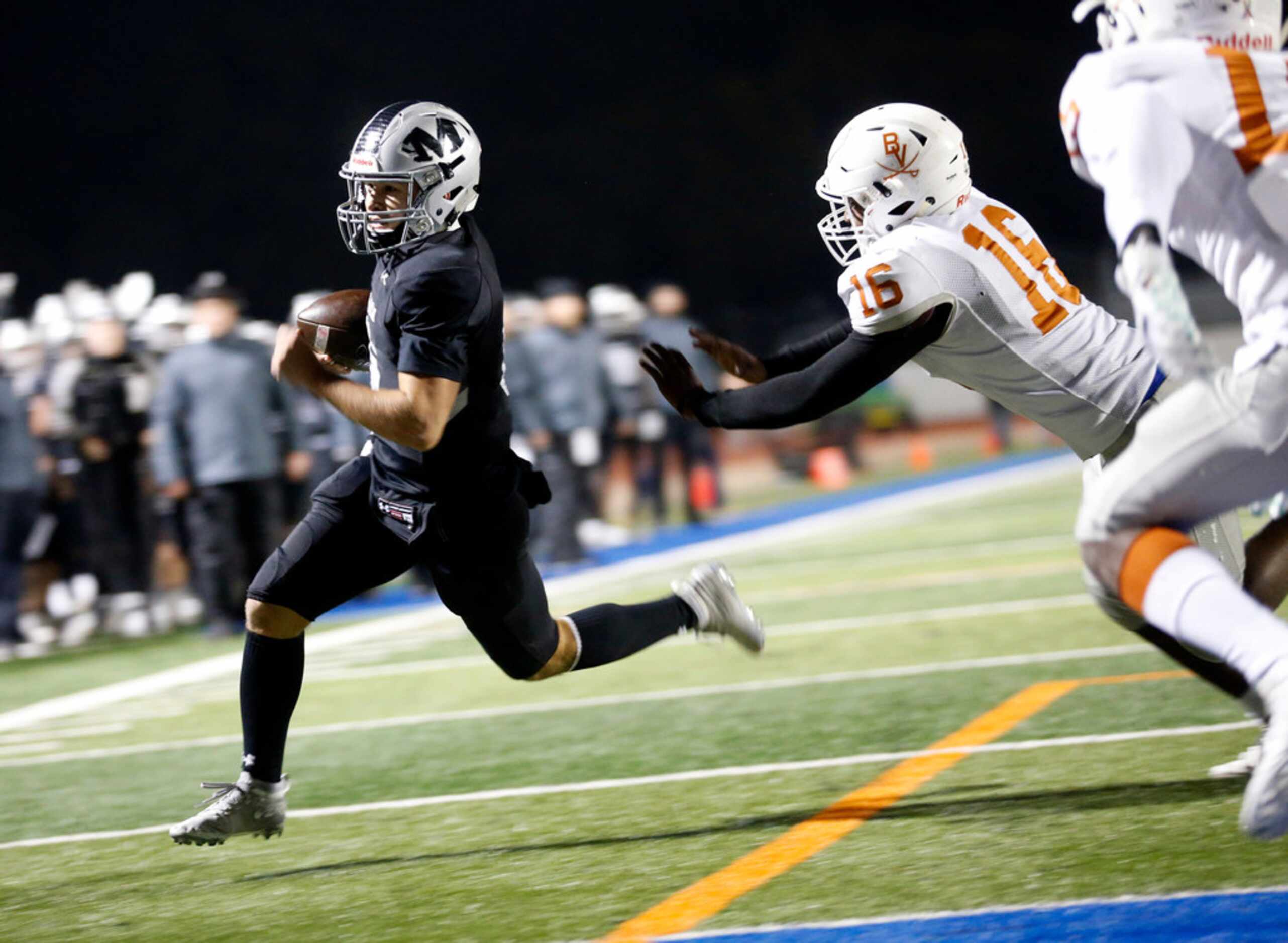 Martin quarterback Zach Mundell (6) carries the ball around the end for a second quarter...