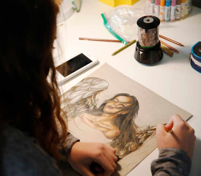 Lilly Heit, 16, works on a project for her AP art class at her Frisco home. Her mother,...