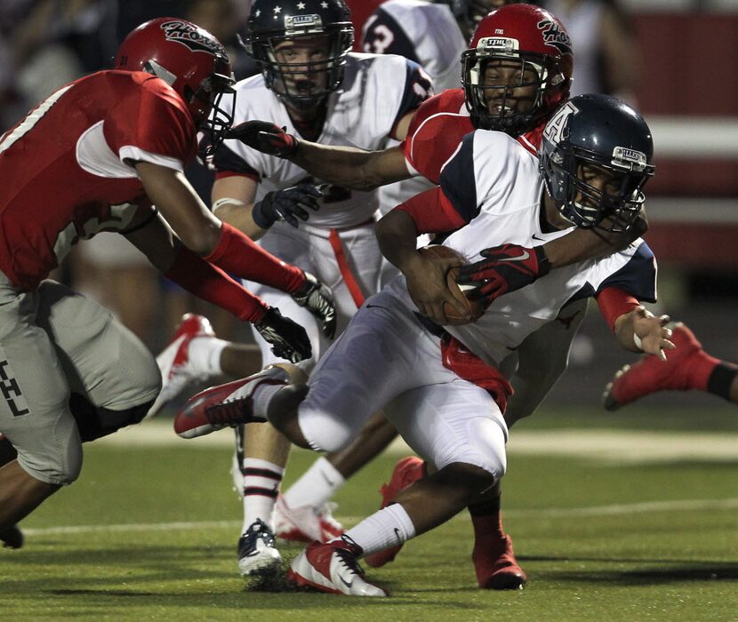 Allen Kyler Murray (1) is tackled by Cedar Hill defender Bobby Jackson (32) in High School...