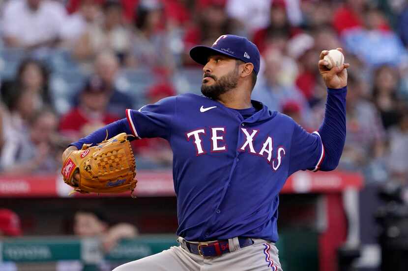 Texas Rangers starting pitcher Martin Perez throws to the plate during the first inning of a...