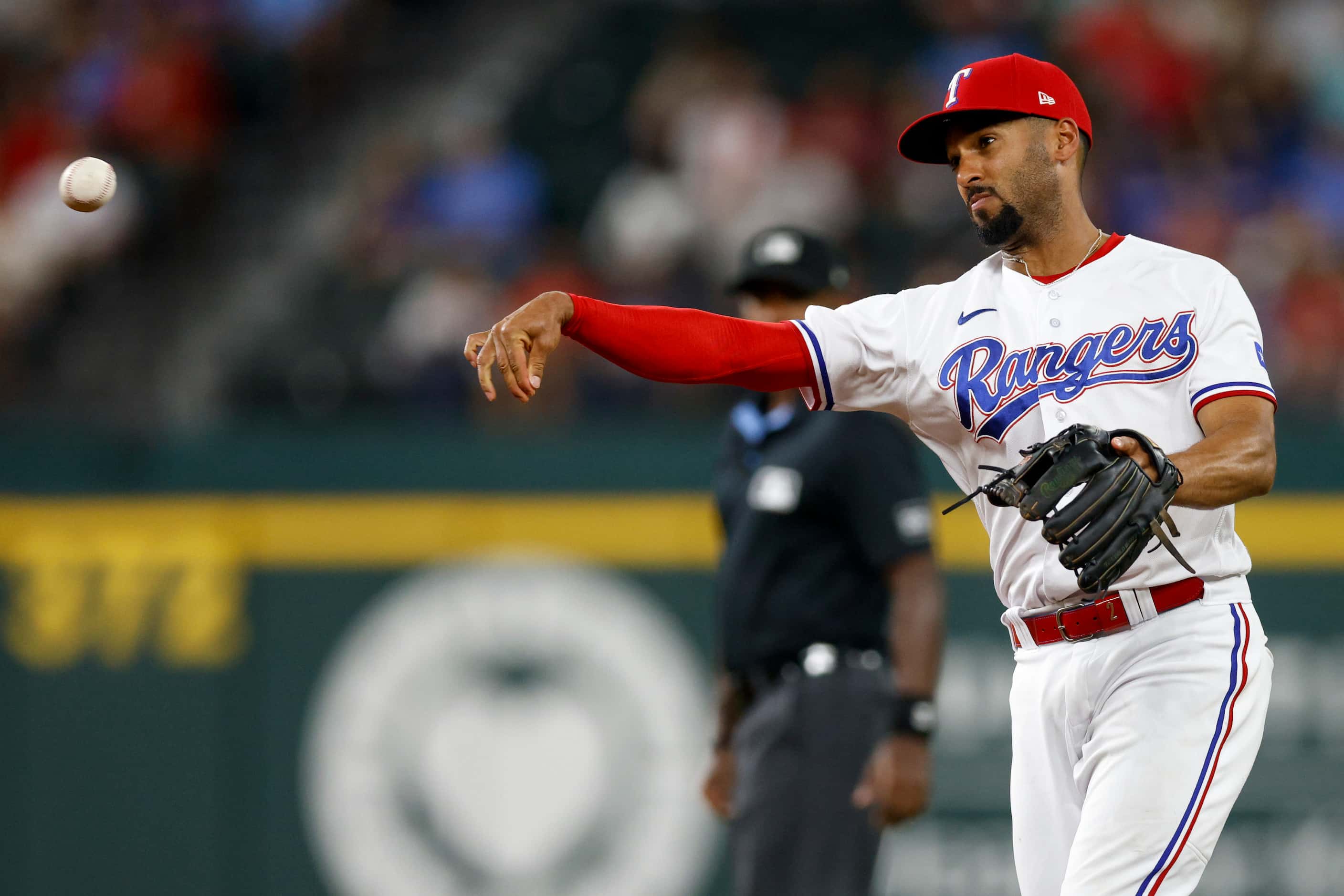 Texas Rangers second baseman Marcus Semien (2) throws to first base for an out in the fourth...