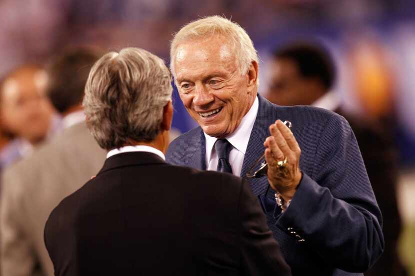 Dallas Cowboys Jerry Jones talks on the field prior to the 2012 NFL season opener between...