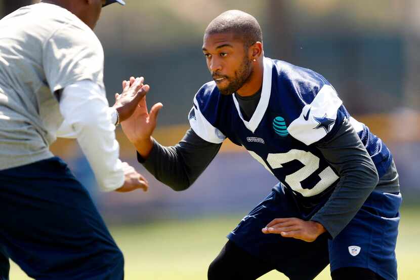 Dallas Cowboys cornerback Orlando Scandrick (32) works one-on-one with a coach during...