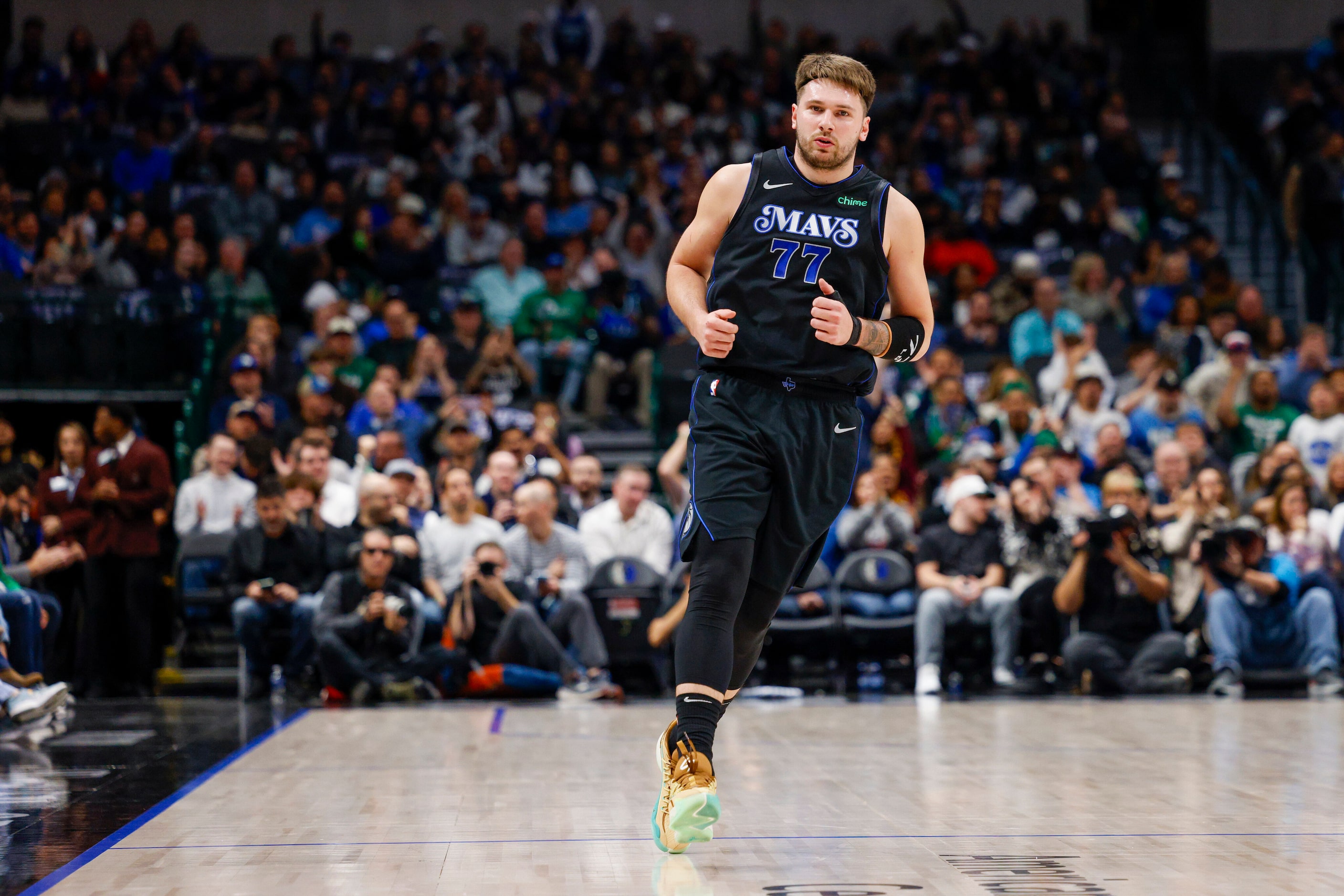 Dallas Mavericks guard Luka Doncic (77) runs backwards down the court after making a basket...