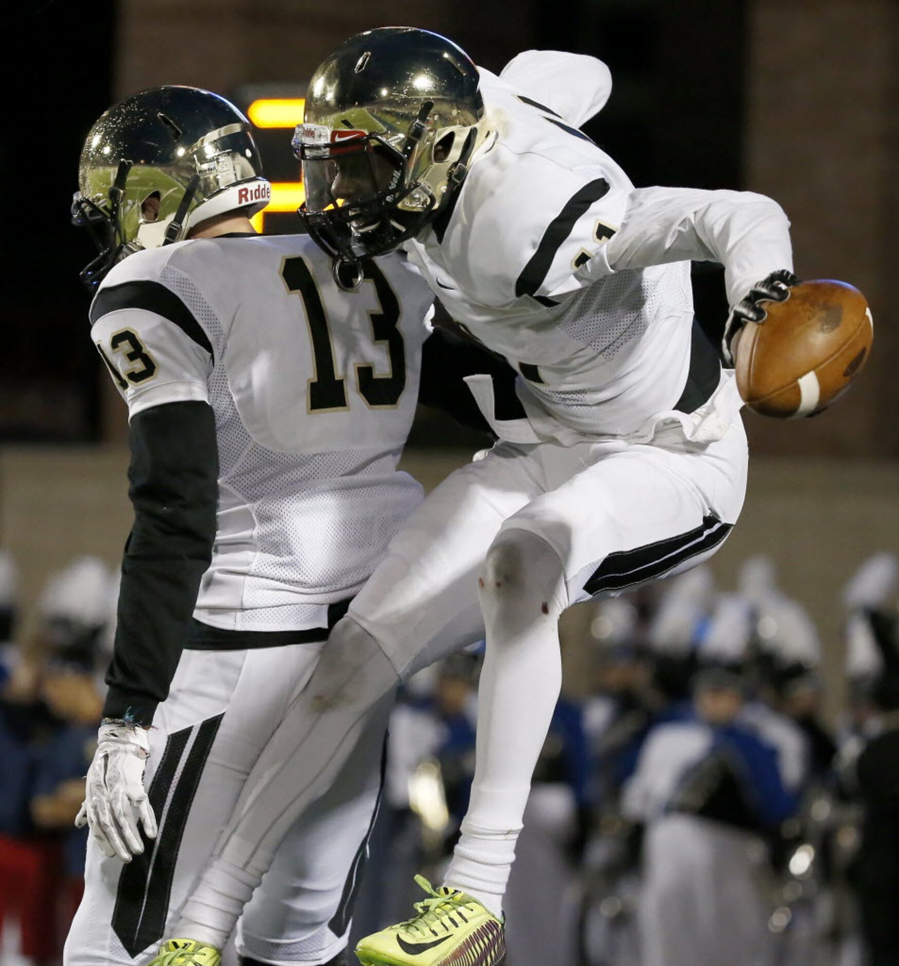 Plano East's Audie Omotosho (11) celebrates for his touchdown with Carson Young (13) against...