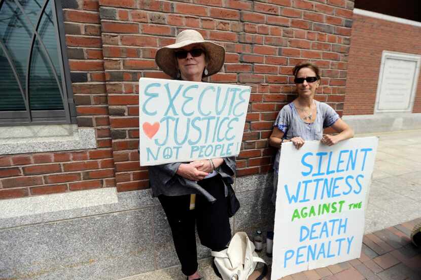  Demonstrators hold signs against the death penalty outside federal court in Boston, where a...