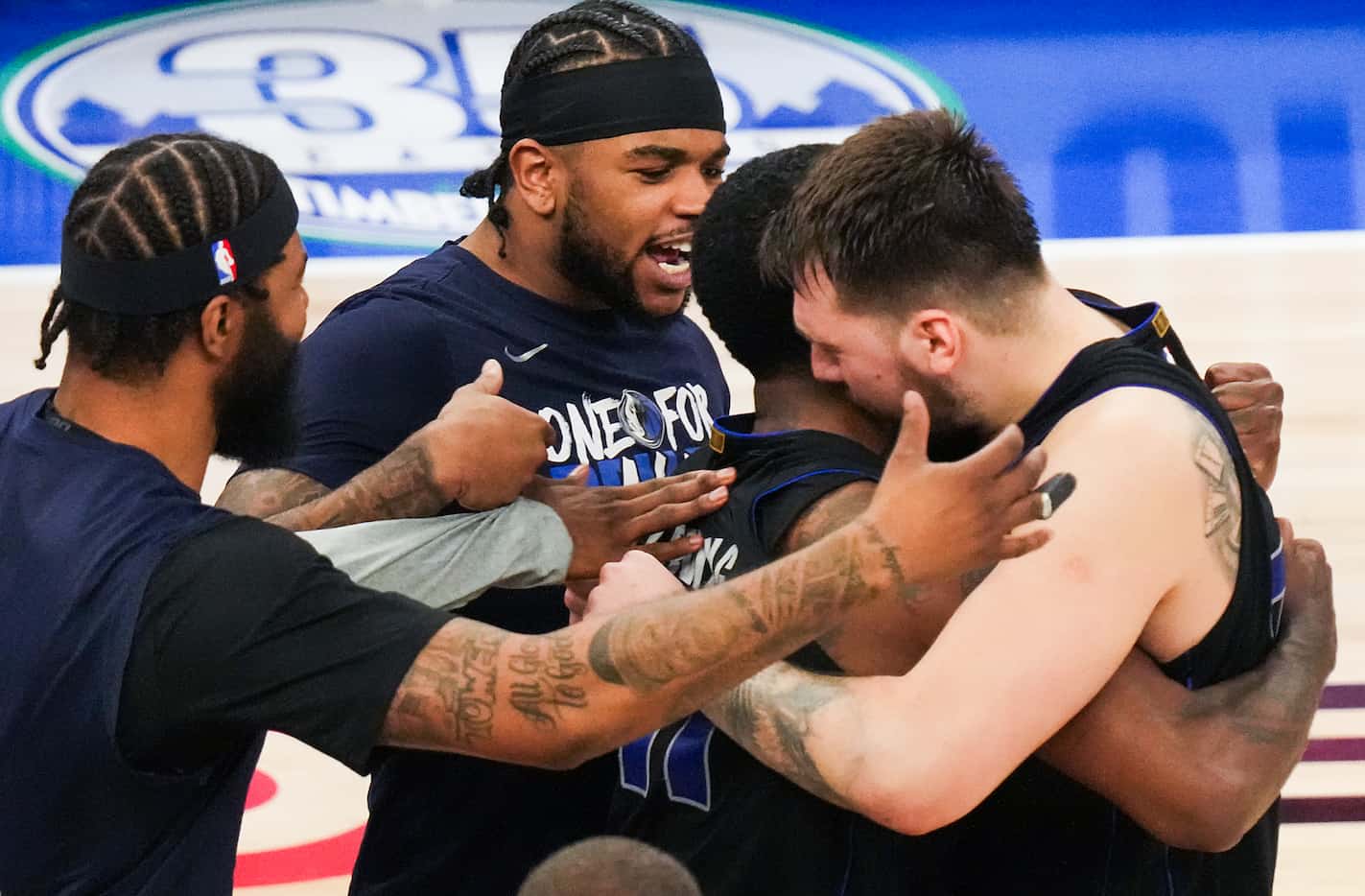 Dallas Mavericks guard Luka Doncic hugs guard Kyrie Irving after hitting a game-winning...