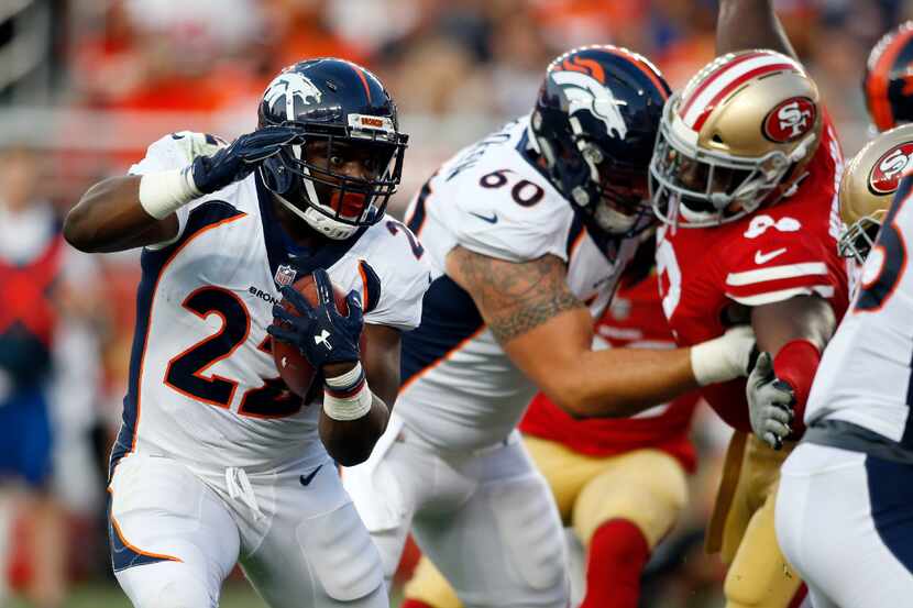 Denver Broncos running back C.J. Anderson (22) runs for a touchdown during the first half of...