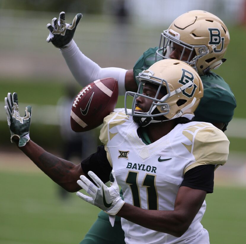 Baylor wide receiver Pooh Stricklin (11) attempts a catch as safety Jourdan Blake (23)...