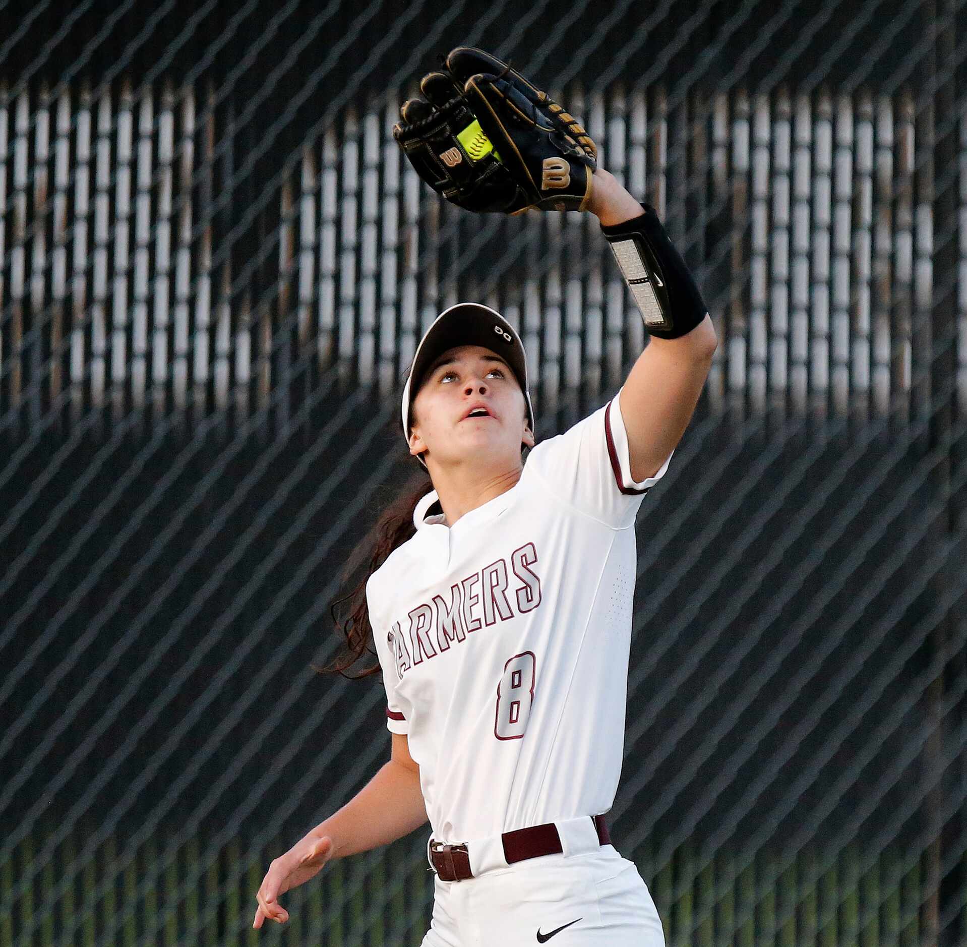 Lewisville High School left fielder Rylee Brice (8) catches an out in the first inning as...
