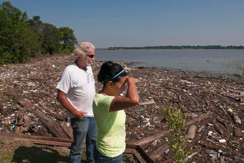 
Chuck Slater and his wife, Irene, stand amid the debris that collected near their home on...