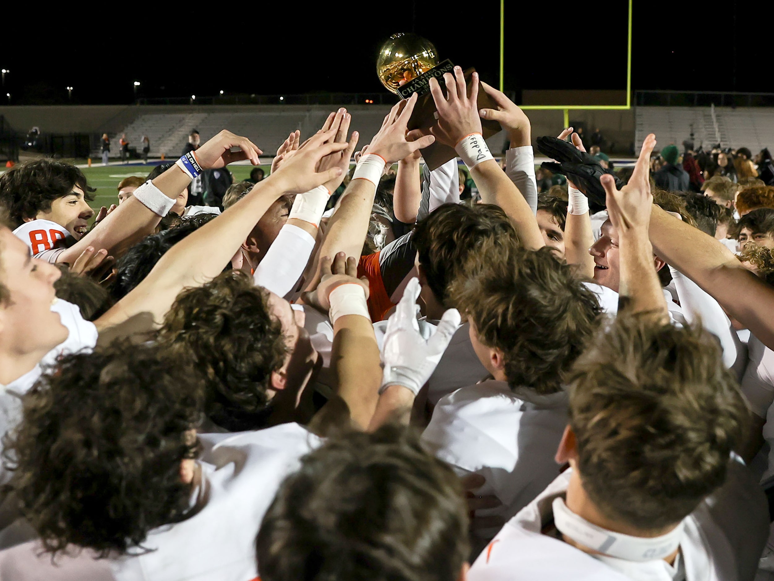 The Celina Bobcats hold up their trophy after defeating Kennedale, 49-7 in the Class 4A...