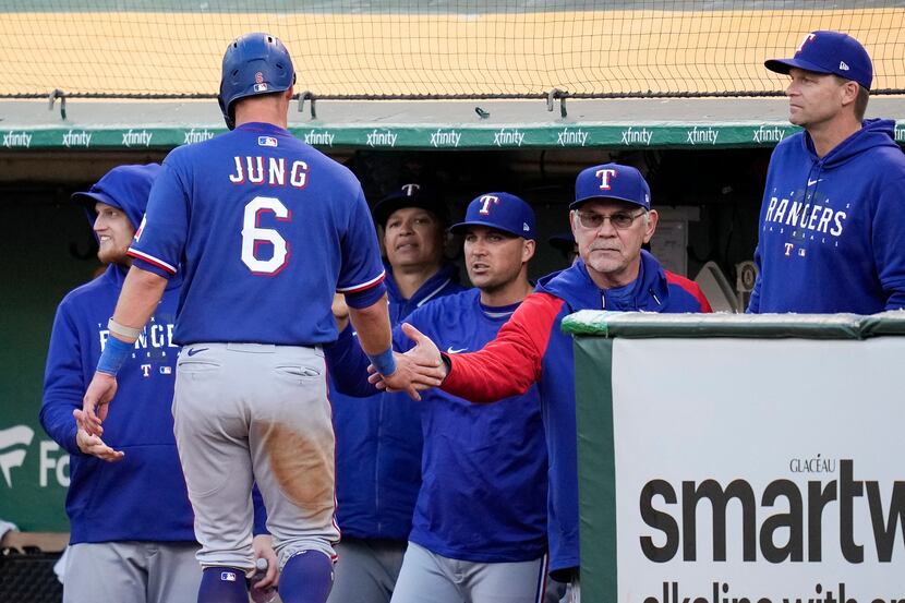 Texas Rangers' Josh Jung, left, celebrates with manager Bruce Bochy after scoring against...