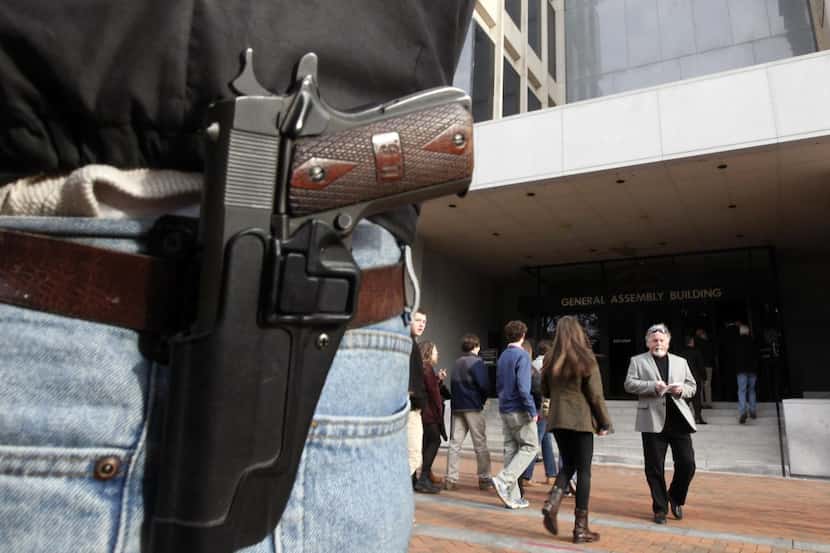
A pistol is worn by gun-rights advocate John Savarese, from Chesterfield County, Va., as he...